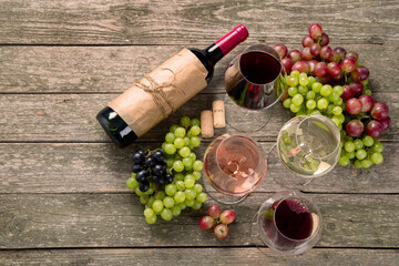 Variety of wine and snack set. Different types of grapes. Fresh ingredients on wooden background.