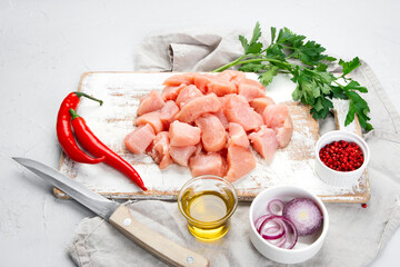 Raw and marinated chicken fillet on light background. Dietary meat.