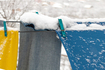 Clothes on the wire outside in the snow