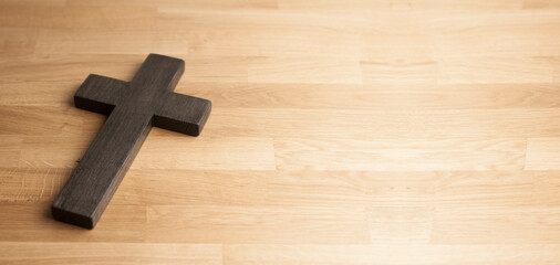 Wooden cross of Jesus on a wooden background. Calvary