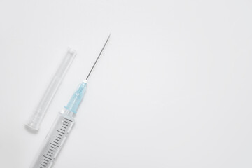 One single syringe with dose of medicine or vaccine on white or gray background with a place for...