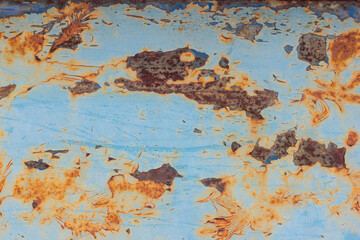 An old blue painted wall with spots and streaks of rust.Rusty metal background. Rust stains.
