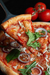 Tasty appetizing vegetarian pizza on dark stone background, top view 