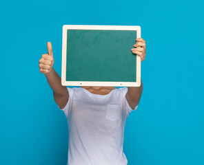 casual woman hiding behind a green board