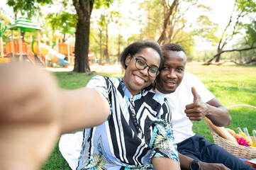 Fototapeta premium couple black people selfie in garden 