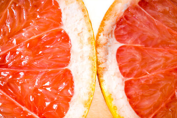 A half of a grapefruit on a cutting board.