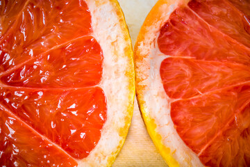 A half of a grapefruit on a cutting board.