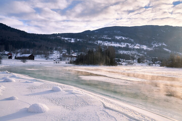 The river is about to freeze. It is very cold and the river is much warmer than the air, therefore...