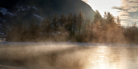 The river is about to freeze. It is very cold and the river is much warmer than the air, therefore the smoke or the damp from the river. Shot at Gol, Norway in February. Minus 20 degreases Celsius.  © SteinOve
