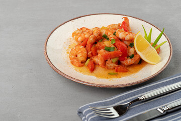Stir fried seafood with sauce on plate with napkin
