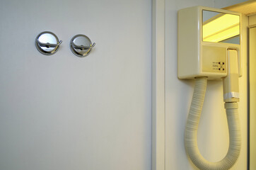 Dated and old fashioned interior design hair dryer and razor power socket outlet in bathroom of...