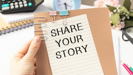 Person writing Share your story in hand. Storytelling Concept..