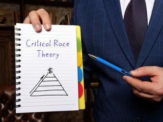 Financial concept about Critical Race Theory with sign on the white notepad.