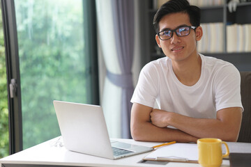 asian young student man entrepreneur working with computer studying learning online at home. e-learning webinar meeting. social distance in covid pandemic