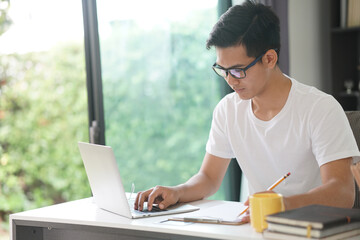 asian young student man entrepreneur working with computer studying learning online at home....