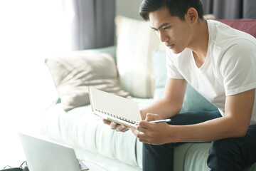 asian young student man entrepreneur working with computer studying learning online at home....