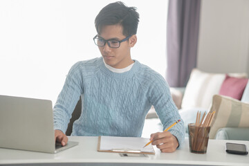 asian young student man entrepreneur working with computer studying learning online at home....