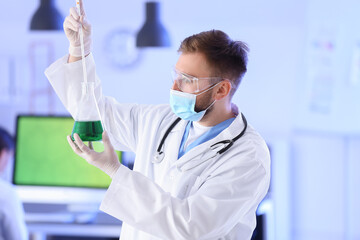 Scientist studying sample in laboratory