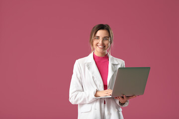 Young woman with laptop on color background