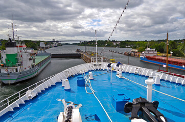 View over bow of classic cruiseship or cruise ship liner and other cargo and container and tanker...