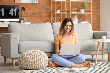 Young woman with laptop at home