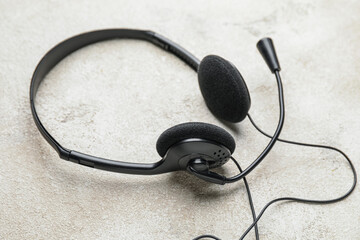 Headphones with microphone on grunge background
