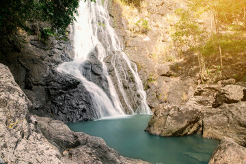Fototapeta na wymiar Beautiful waterfall nature scenery of deep forest in summer day