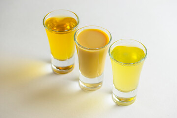 Fresh organic apple cider with apples and cinnamon over white background. Close up three glasses.