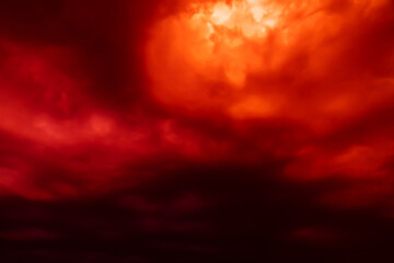 Fantastic concept mystical horror background from another planet from the paranormal world, fantasy style. Dramatic red black orange sky with scary hellish clouds and terrible shadows and light