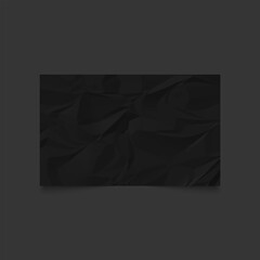 Black crumpled paper on gray background