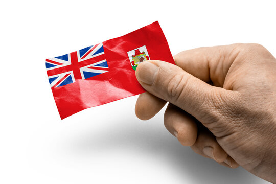 Hand holding a card with a national flag the Bermuda