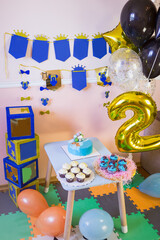Children's photo zone with a candy bar and birthday party decor.