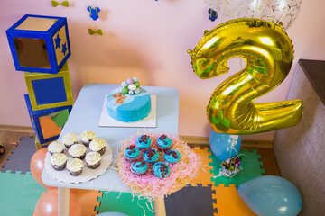 Children's photo zone with a candy bar and birthday party decor.