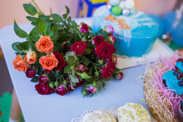 A bouquet of roses on the background of children's birthday party.