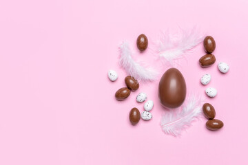 Tasty chocolate eggs on color background