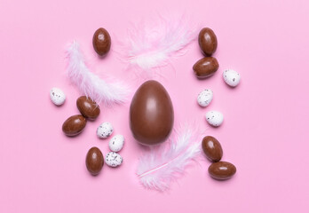 Tasty chocolate eggs on color background