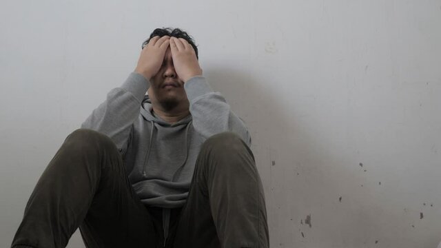 Sad depressed anxiety Asian man thinking contemplating bad thing happened in his life, stress exhausted feeling down expression, financial or relationship problem