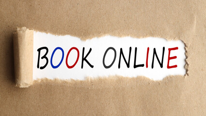 BOOK ONLINE. text on white paper over torn paper background.
