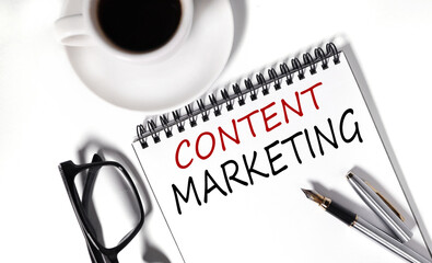 content marketing, text on white notepad paper on white background. near a cup of coffee