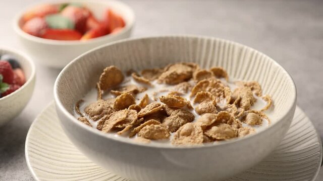 Breakfast cereals with milk and berries, the camera moves along, close-up 
