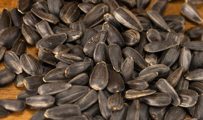 sunflower seeds are scattered on a wooden table. a lot of raw seeds. High quality photo