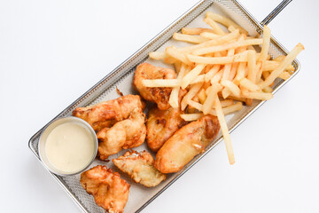 Fried shrimp meat balls with sweet sauce and french fries served in a metal tray over white background.