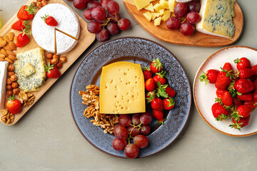 Composition of cheese, and fruits on gray table