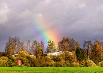 autumn landscape with a rainbow over beautiful colorful trees