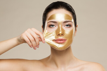 Woman peel off Gold Facial Mask. Collagen Golden Anti Aging Wrinkle Lifting Mask. Spa Beauty...