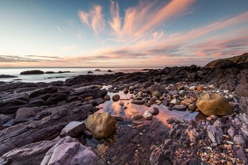 A pink sunset reflecting in rock pools at Hallett Cove South Australia