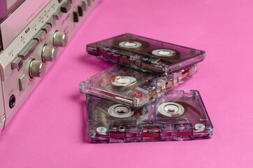 Boombox Stereo Radio Cassette Recorder and random cassettes on pink background.