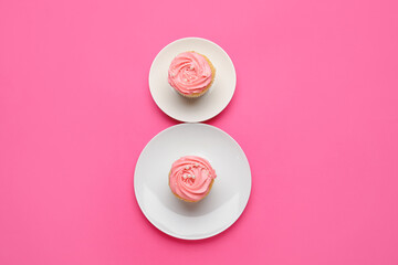 Figure 8 made of plates with cupcakes on color background. International Women's Day celebration