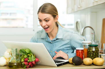 Young woman cooking recipe from the Internet. High quality photo