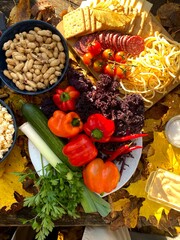 table with food top view. vegetables, nuts, snacks on the table with autumn leaves